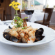 Michael's Back Door LINGUINE PESCATORE This linguine pasta dish (shown in photo) featuring fresh shrimp, scallops, mussels and clams in a white wine garlic basil tomato sauce has been a seafood lovers dream since 1981.