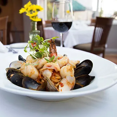 Michael's Back Door LINGUINE PESCATORE This linguine pasta dish (shown in photo) featuring fresh shrimp, scallops, mussels and clams in a white wine garlic basil tomato sauce has been a seafood lovers dream since 1981.